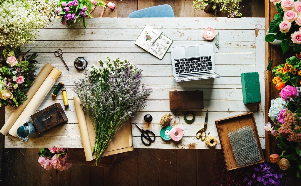 Florist workbench with fresh flowers and design tools